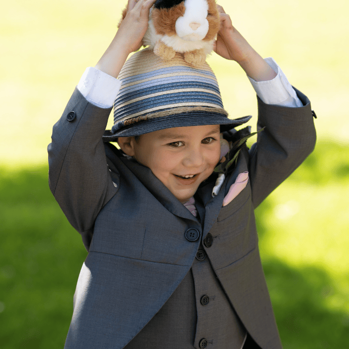 Child in morning suit holding a toy hamster - Camellio Wedding Planning and Events - Essex Wedding Planner