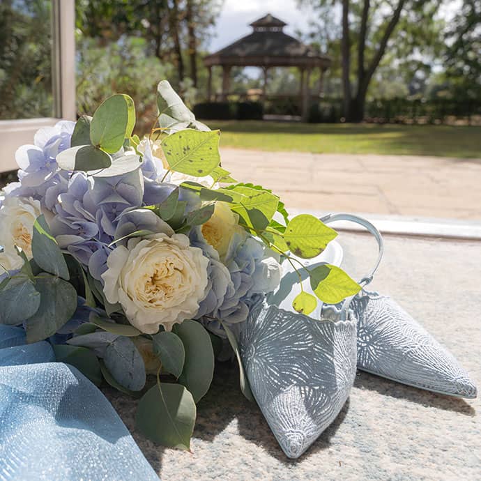 Flowers and shows in sun with garden gazebo in the background - Camellio Wedding Planning and Events - Essex Wedding Planner