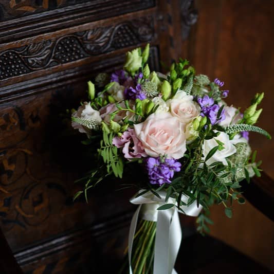 Wedding Boquet standing on a dark mahogany chair - Camellio Wedding Planning and Events - Essex Wedding Planner