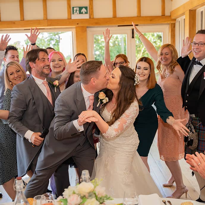 Newly wed couple kissing, flash mob entrance to theirwedding breakfast