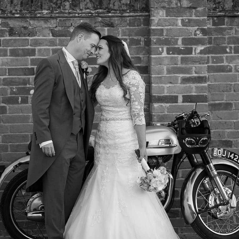 Wedding couple in front of vintage motorbike