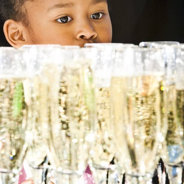 Young girl looking at wedding reception champagne